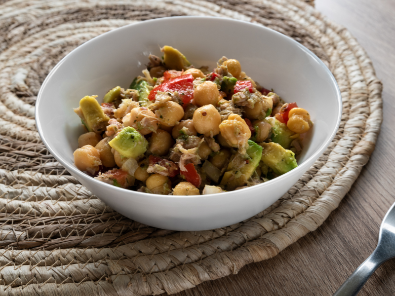 Healthy tuna and chickpea salad meal prep boxes with fresh vegetables and herbs